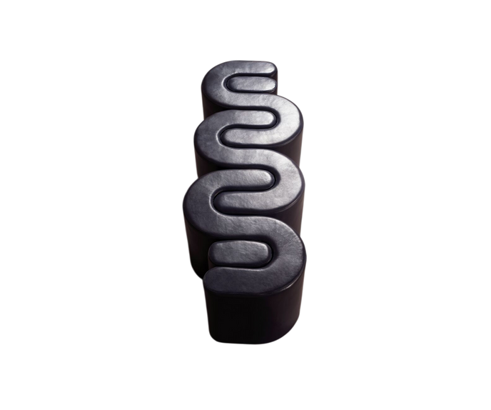 Baxter Adel leather bench with sculptural curved design.