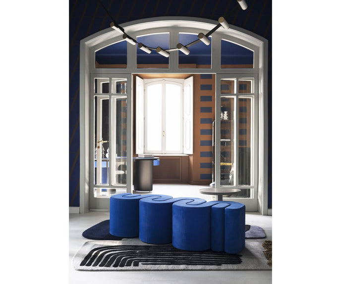 Baxter Adel leather bench with sculptural curved design.