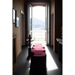 Baxter Adel leather bench with sculptural curved design.
