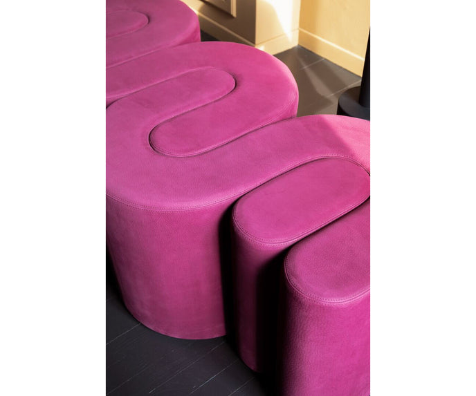 Baxter Adel leather bench with sculptural curved design.
