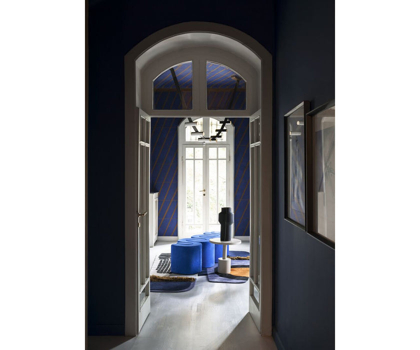 Baxter Adel leather bench with sculptural curved design.