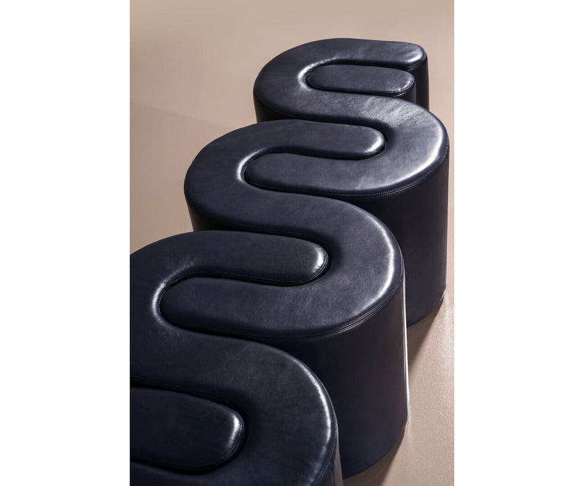 Baxter Adel leather bench with sculptural curved design.