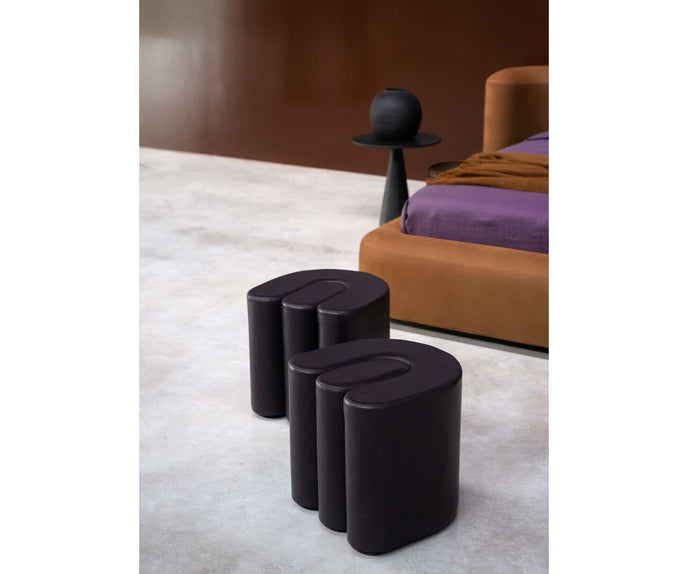Baxter Adel leather pouf with sculptural curved design.