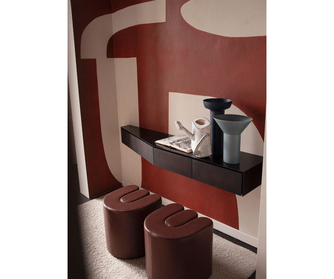 Baxter Adel leather pouf with sculptural curved design.