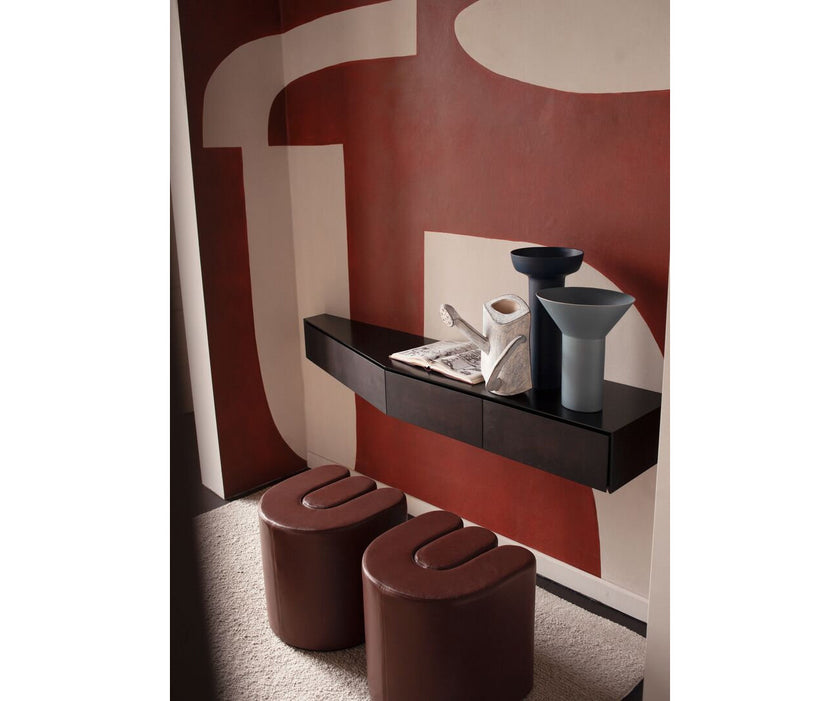 Baxter Adel leather pouf with sculptural curved design.