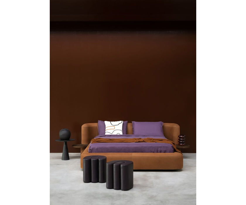 Baxter Adel leather pouf with sculptural curved design.
