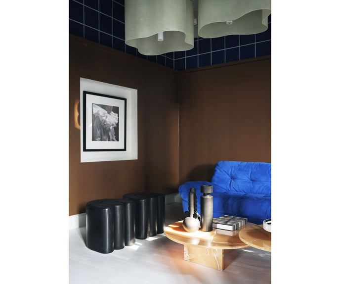 Baxter Adel leather pouf with sculptural curved design.