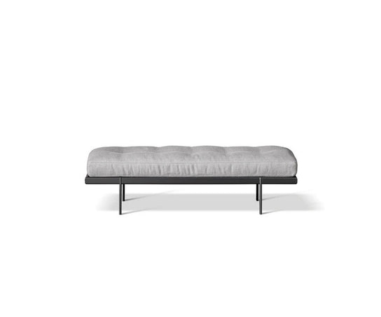 Bonaldo James upholstered bedroom bench with padded seat and painted metal base in a contemporary bedroom setting.