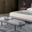 Bonaldo James upholstered bedroom bench with padded seat and painted metal base in a contemporary bedroom setting.