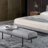 Bonaldo James upholstered bedroom bench with padded seat and painted metal base in a contemporary bedroom setting.
