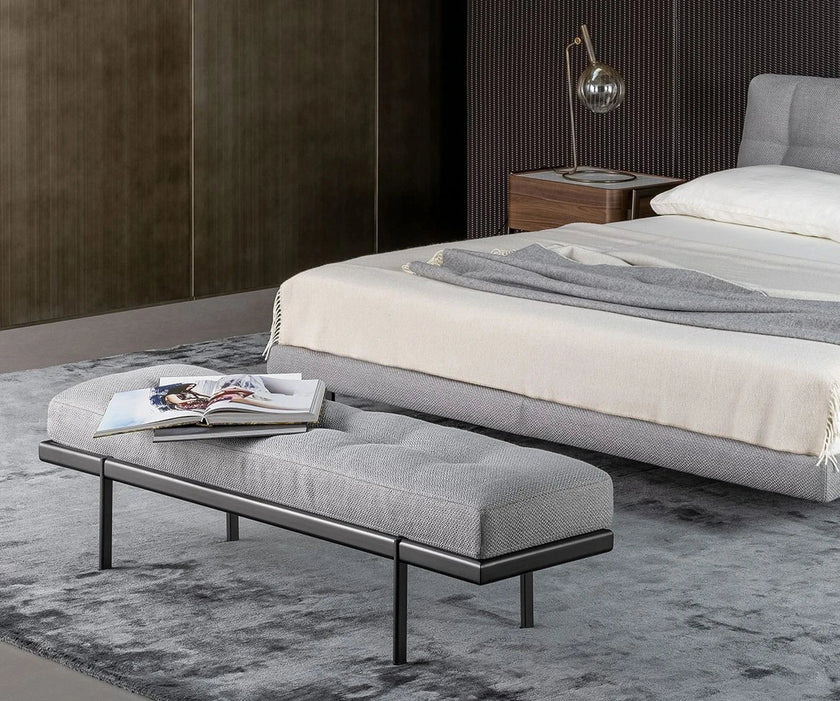 Bonaldo James upholstered bedroom bench with padded seat and painted metal base in a contemporary bedroom setting.