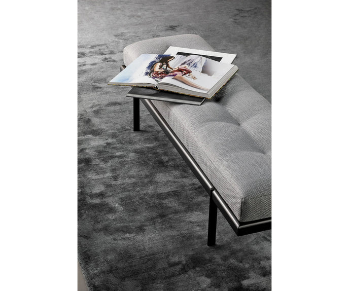 Bonaldo James upholstered bedroom bench with padded seat and painted metal base in a contemporary bedroom setting.