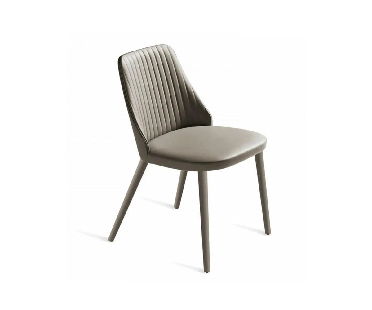 Break 1644 dining chair by Bross with quilted upholstery and beechwood legs Casa Design Group