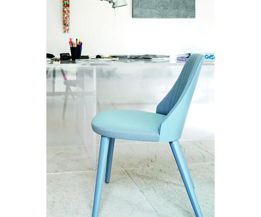Break 1644 dining chair by Bross with quilted upholstery and beechwood legs Casa Design Group