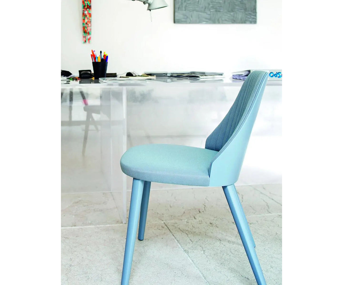 Break 1644 dining chair by Bross with quilted upholstery and beechwood legs Casa Design Group