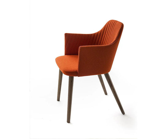 Break 1645 dining armchair by Bross with quilted upholstery and beechwood legs Casa Design Group