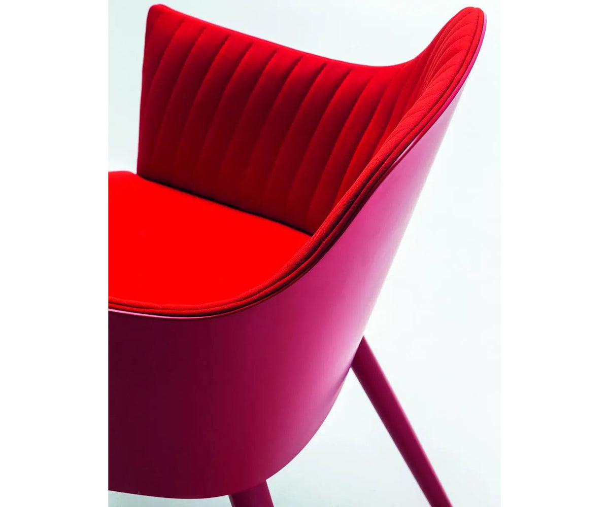 Break 1645 dining armchair by Bross with quilted upholstery and beechwood legs Casa Design Group