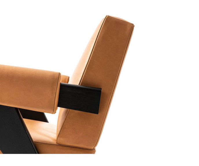Capitol Complex Lounge Chair by Cassina inspired by Pierre Jeanneret with a solid wood frame and upholstered cushions.