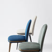 Cremino Dining Chair with rounded upholstered backrest, slender tapered legs and decorative metal ring by Accento | Casa Design Group