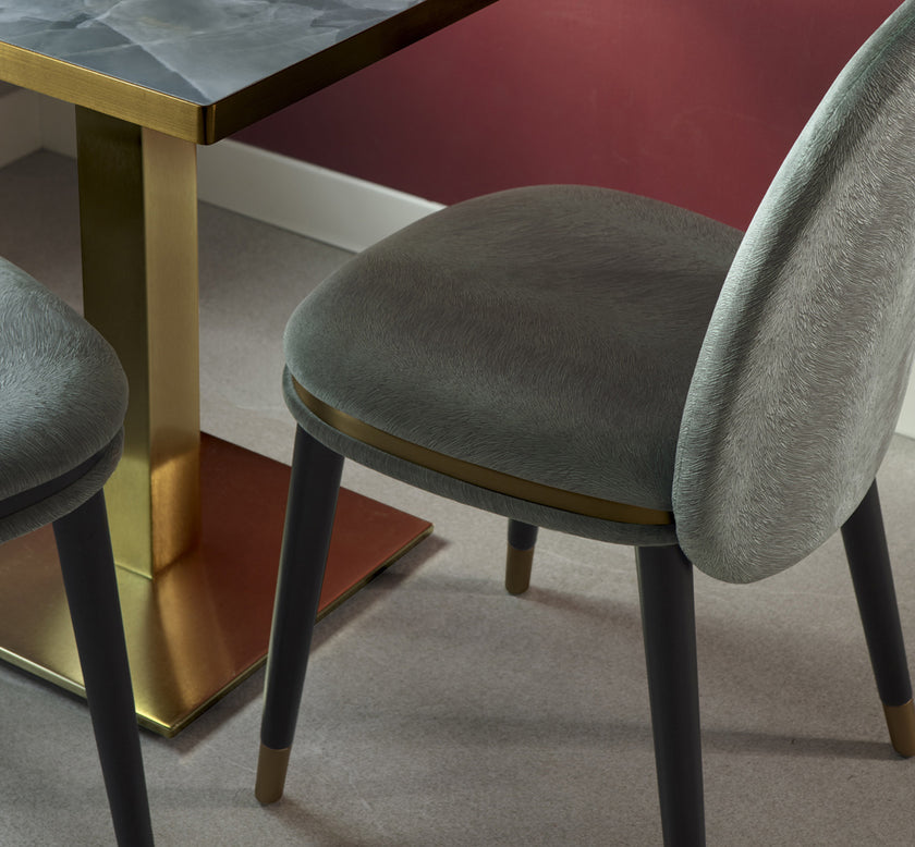 Cremino Dining Chair with rounded upholstered backrest, slender tapered legs and decorative metal ring by Accento | Casa Design Group