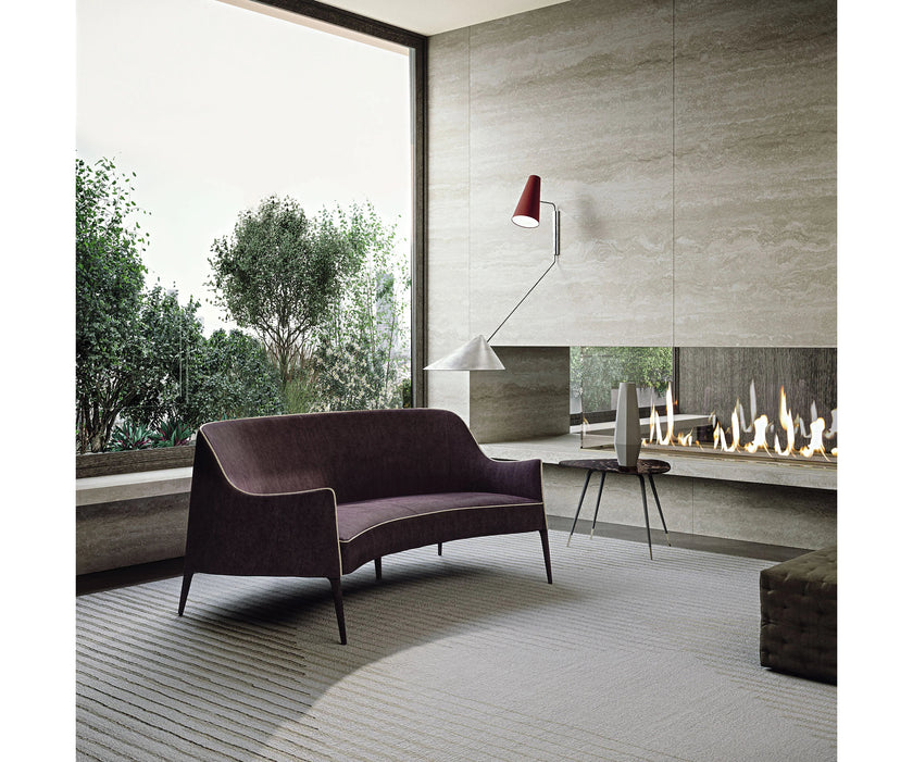 Jackie Bergère Sofa by Frigerio featuring a curved silhouette, sculpted armrests, and a high enveloping backrest | Casa Design Group