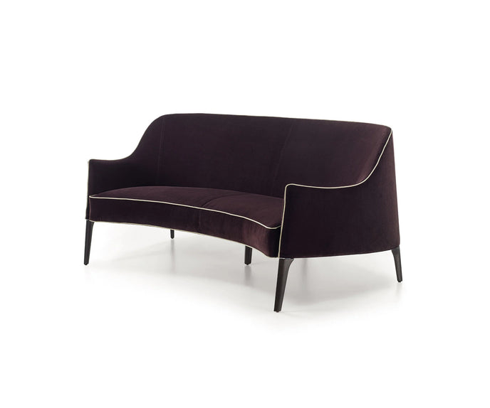 Jackie Bergère Sofa by Frigerio featuring a curved silhouette, sculpted armrests, and a high enveloping backrest | Casa Design Group
