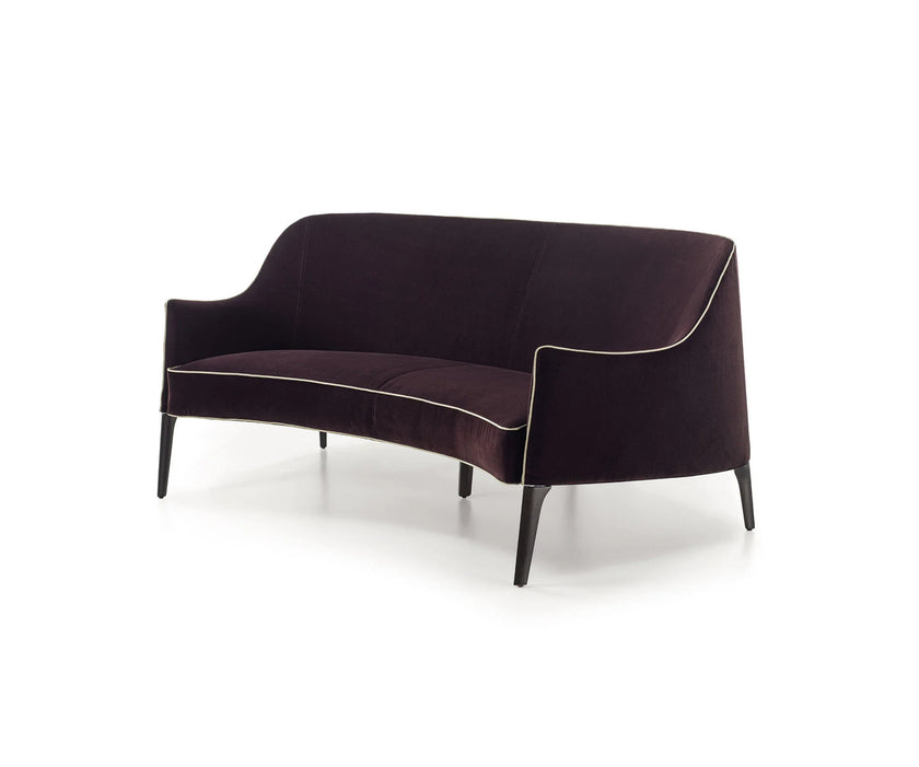 Jackie Bergère Sofa by Frigerio featuring a curved silhouette, sculpted armrests, and a high enveloping backrest | Casa Design Group