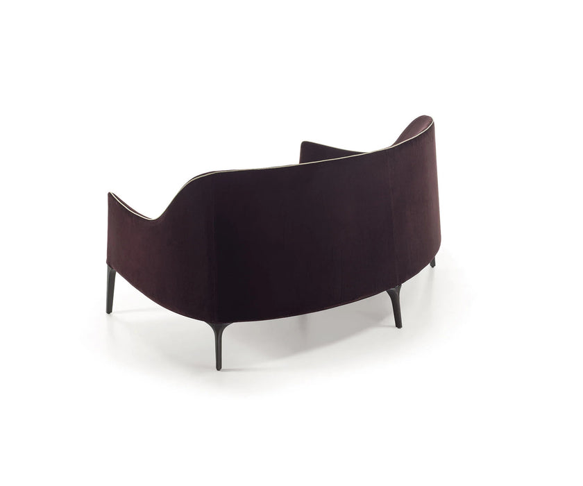 Jackie Bergère Sofa by Frigerio featuring a curved silhouette, sculpted armrests, and a high enveloping backrest | Casa Design Group