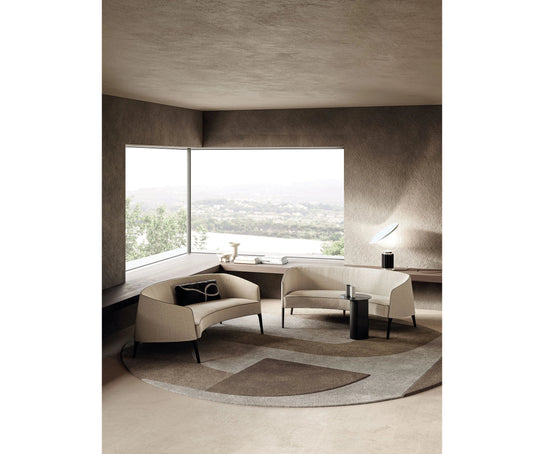 Jackie Sofa by Frigerio featuring a curved silhouette, sculpted armrests, and refined Italian craftsmanship | Casa Design Group
