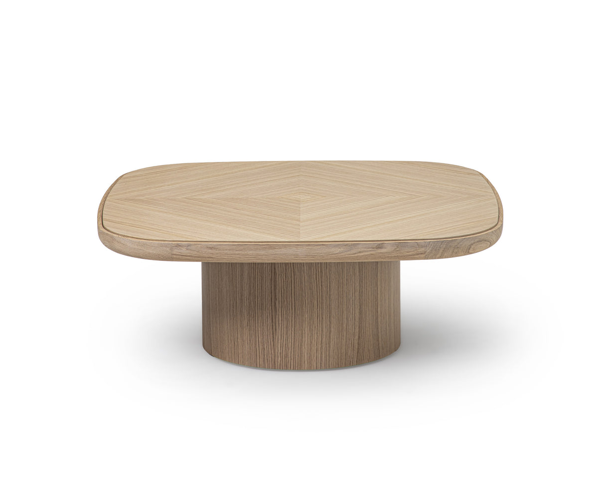 Enook coffee table crafted from solid wood, featuring a square tabletop with rounded corners and a sculptural cylindrical base in a contemporary design.