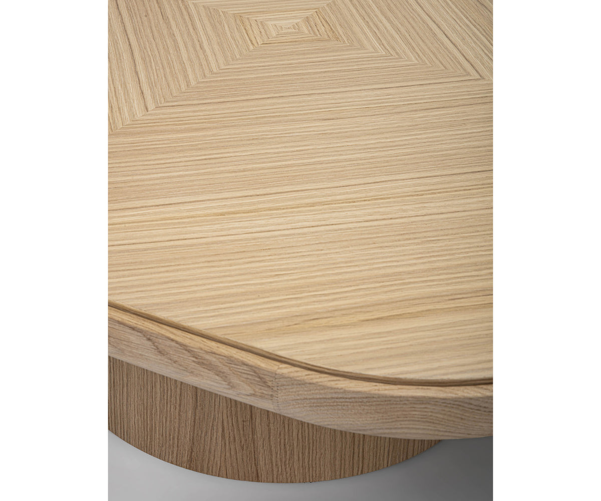 Enook coffee table crafted from solid wood, featuring a square tabletop with rounded corners and a sculptural cylindrical base in a contemporary design.
