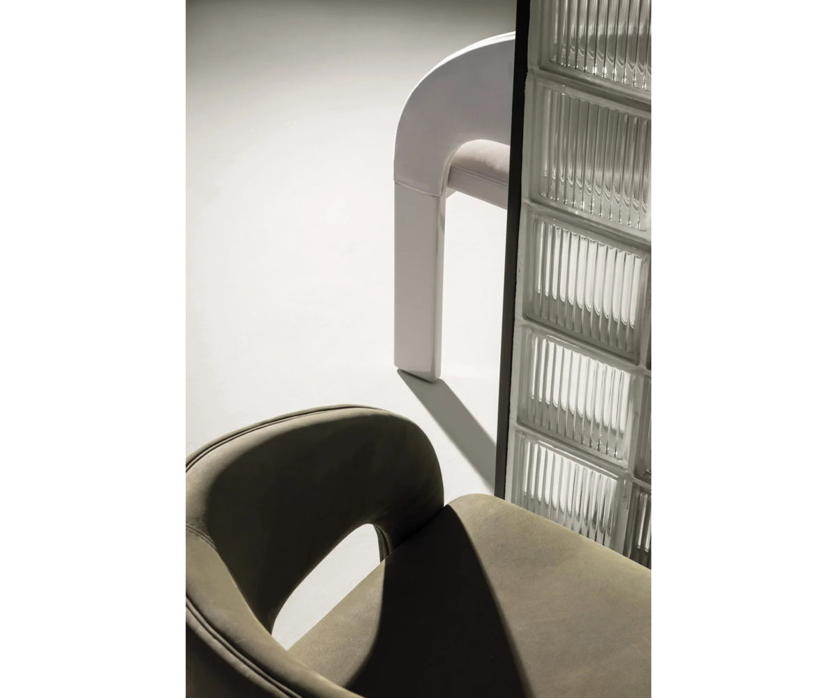 Contemporary Fosca dining chair by Frigerio with sculptural upholstered design