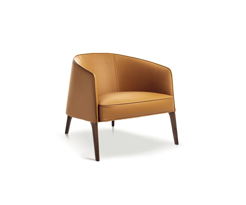 Frigerio Jackie upholstered armchair with solid ashwood legs and tailored fabric or leather upholstery, available at Casa Design Group.