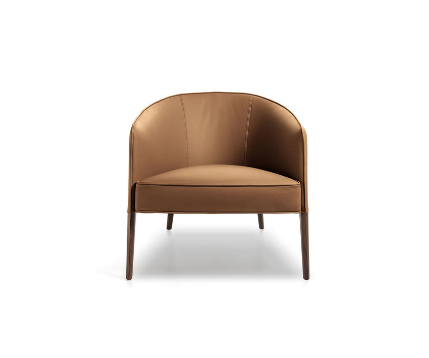 Frigerio Jackie upholstered armchair with solid ashwood legs and tailored fabric or leather upholstery, available at Casa Design Group.