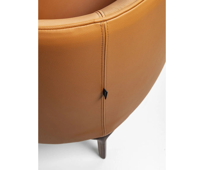 Frigerio Jackie upholstered armchair with solid ashwood legs and tailored fabric or leather upholstery, available at Casa Design Group.
