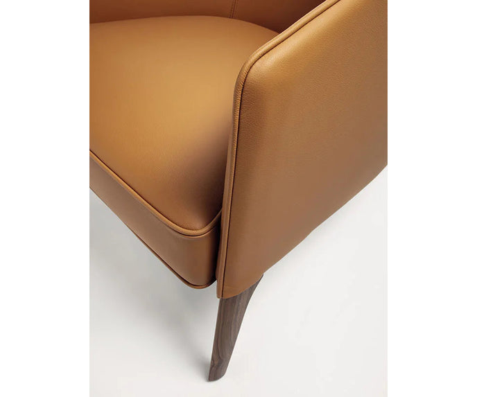 Frigerio Jackie upholstered armchair with solid ashwood legs and tailored fabric or leather upholstery, available at Casa Design Group.