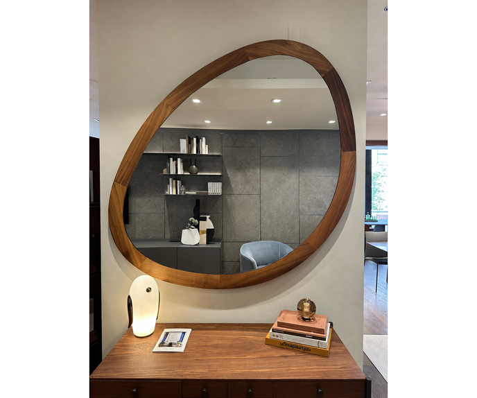 Giolo floor sample mirror by Porada with sculptural Canaletta walnut frame | Casa Design Group