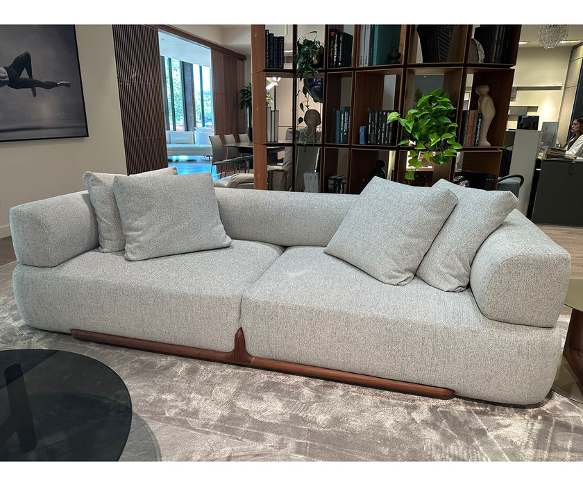 Klem floor sample sofa by Porada with Canaletta walnut frame and upholstered seating | Casa Design Group