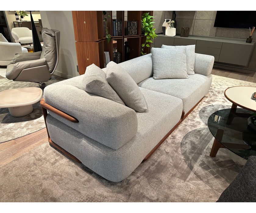 Klem floor sample sofa by Porada with Canaletta walnut frame and upholstered seating | Casa Design Group