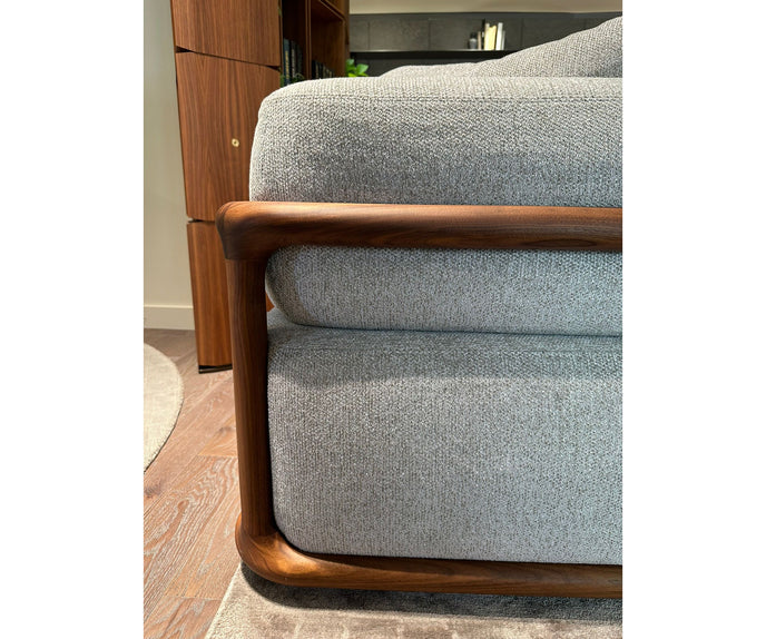 Klem floor sample sofa by Porada with Canaletta walnut frame and upholstered seating | Casa Design Group