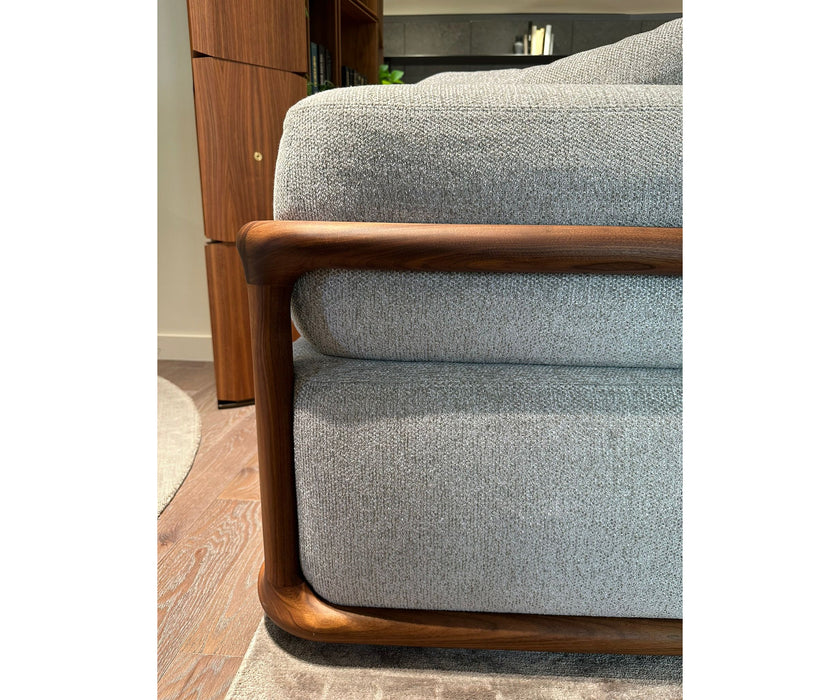 Klem floor sample sofa by Porada with Canaletta walnut frame and upholstered seating | Casa Design Group