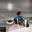 Kor Sculptural C Table with Natural Stone Top and Polished Steel Base by Baxter | Casa Design Group
