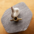 Kor Sculptural C Table with Natural Stone Top and Polished Steel Base by Baxter | Casa Design Group