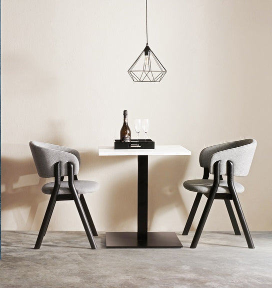 Lambda S Dining Chair with sculpted wooden double legs, curved upholstered backrest and padded seat by Accento | Casa Design Group