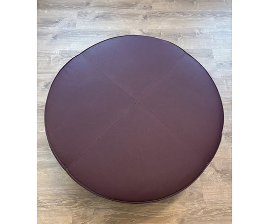 Contemporary burgundy leather round ottoman floor sample – Casa Design Group