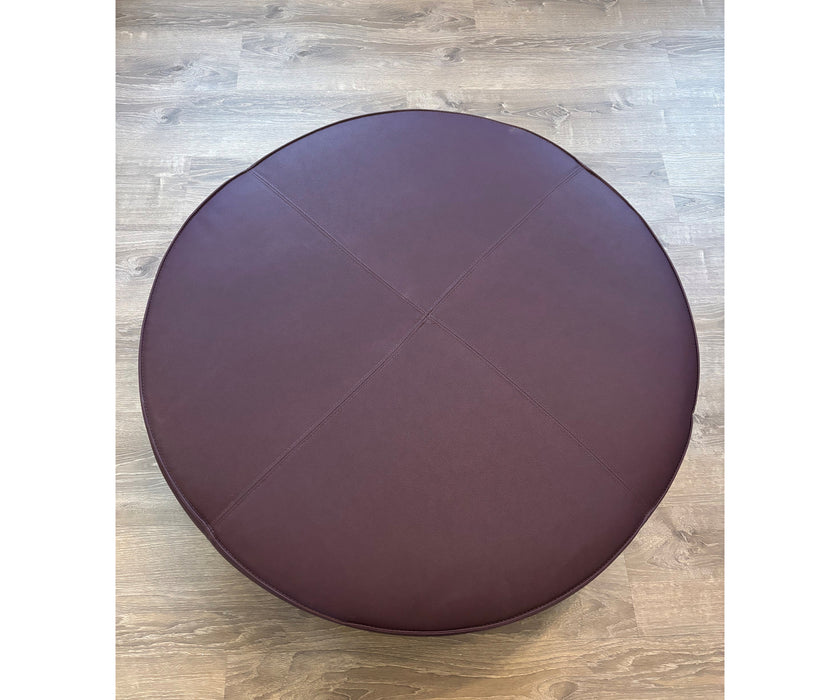 Contemporary burgundy leather round ottoman floor sample – Casa Design Group