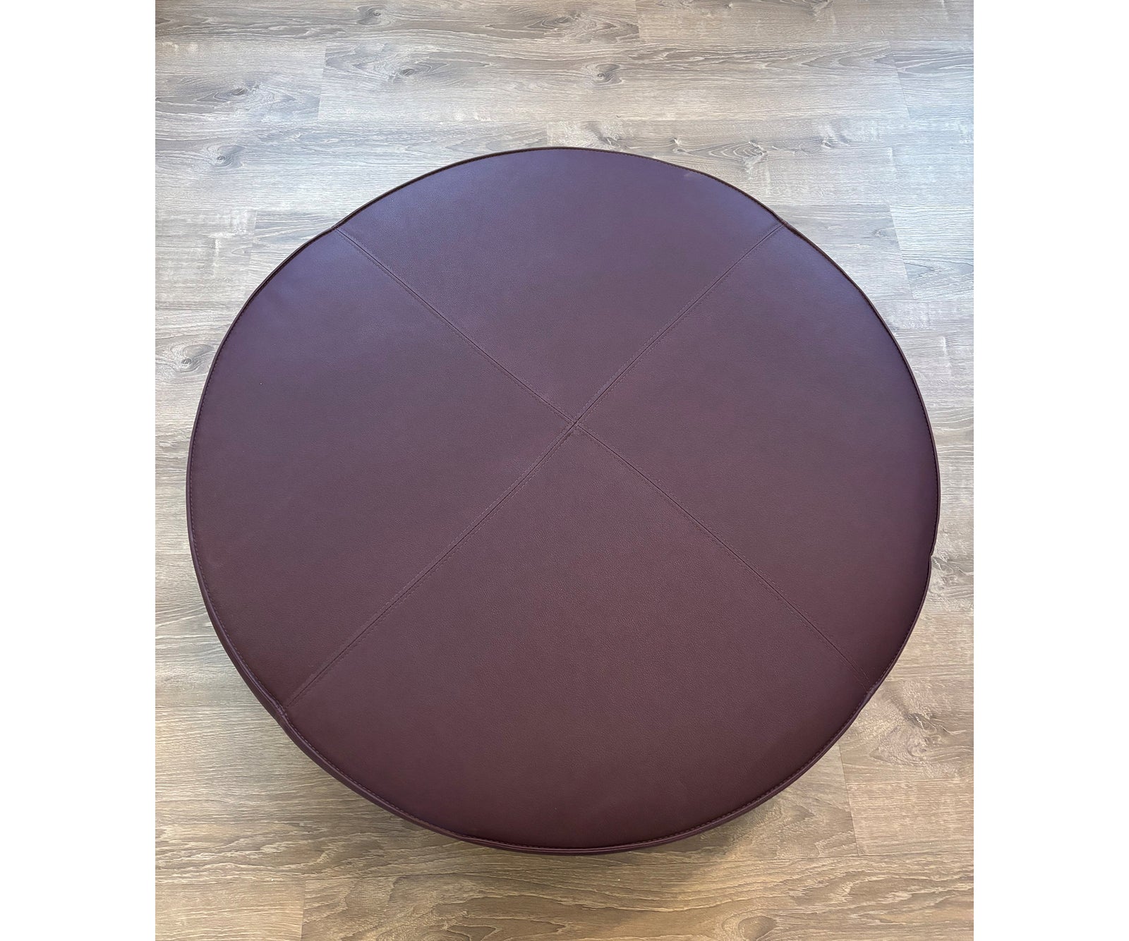 Contemporary burgundy leather round ottoman floor sample – Casa Design Group