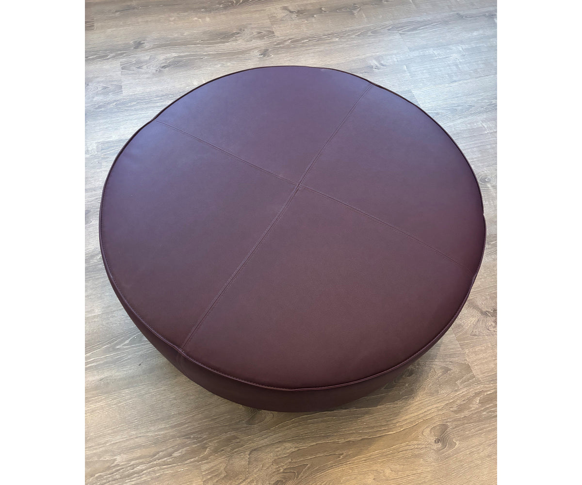 Contemporary burgundy leather round ottoman floor sample – Casa Design Group