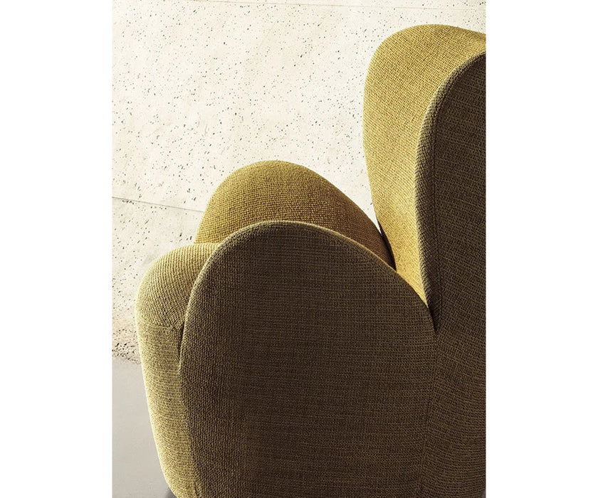 Libelle Armchair by Frigerio featuring a sculptural silhouette inspired by dragonfly wings, upholstered seating, and contemporary Italian design.