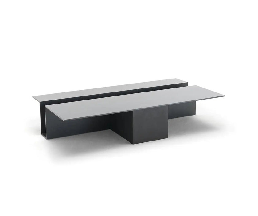 Grek Coffee Table by Living Divani featuring a sculptural design with an integrated magazine holder.